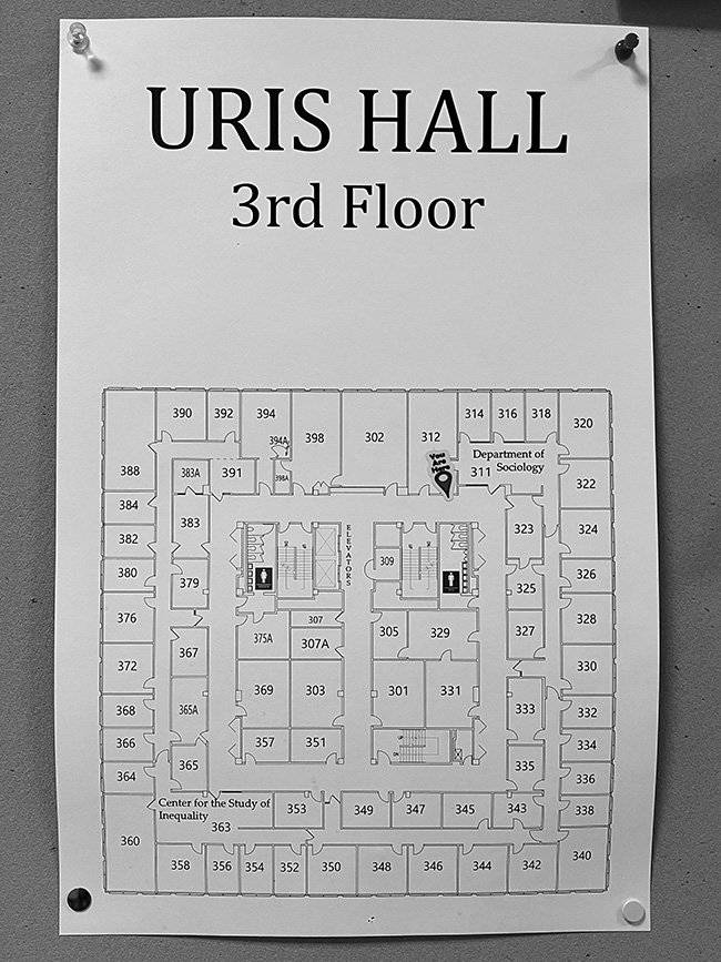 Photo of wall-mounted floor plan for Uris Hall.