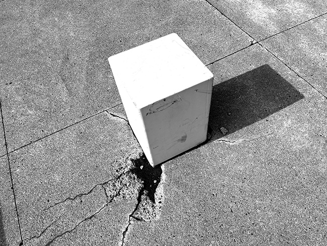 View of bollard showing cracking of slab and slight inclination from the vertical.