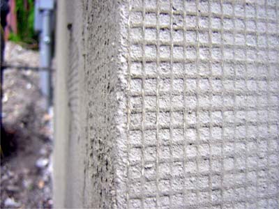 EIFS mesh embedded in base coat, Stewart Ave., Ithaca, NY (photo by J. Ochshorn)