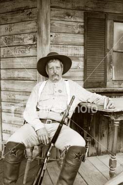 Man with rifle on porch
