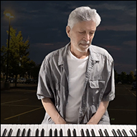 Screen shot from music video showing Jonathan Ochshorn at keyboard